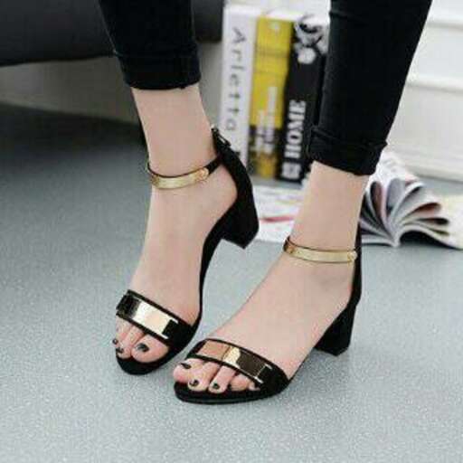 black sandals with gold straps and a gold belt