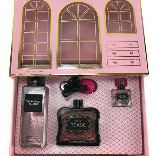 a pink dollhouse with a pink and gold window.