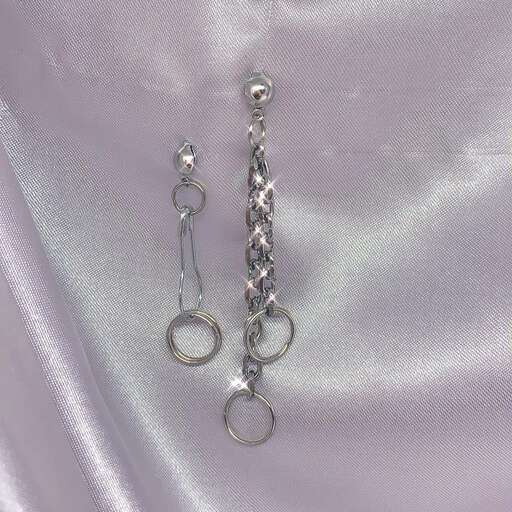 silver earrings with silver hoops on a silver chain.