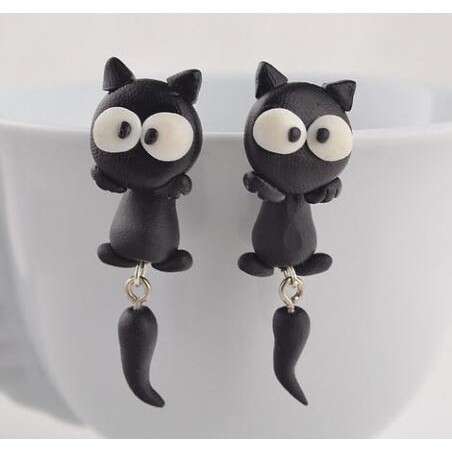 two black cats with silver earrings.