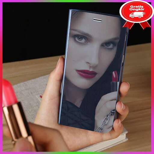 a woman holding a cell phone in her hand.