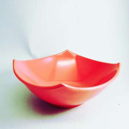 a bowl made of plastic and painted in the style of the 1960s.