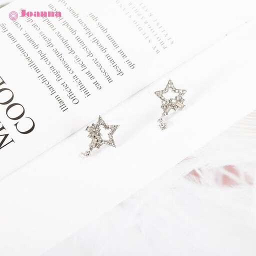 a pair of silver earrings with stars in the middle.