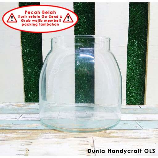 a glass vase sitting on top of a wooden table.