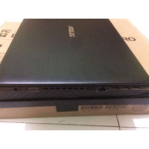 a laptop computer sitting on top of a cardboard box.