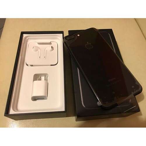 a smart phone and a box on a table.