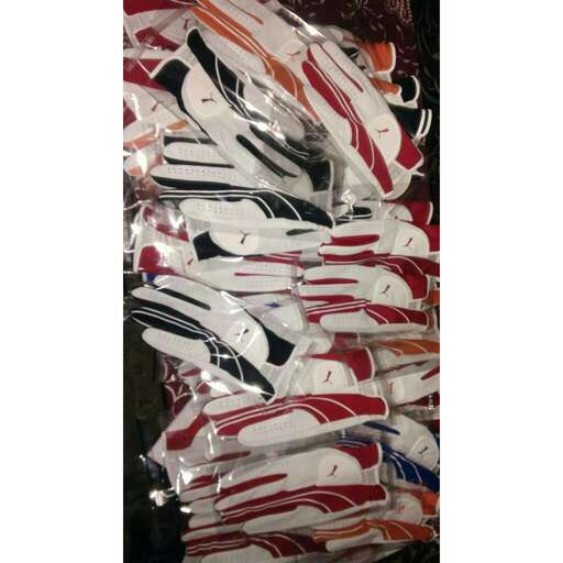 a pile of red and white shoes in a store.