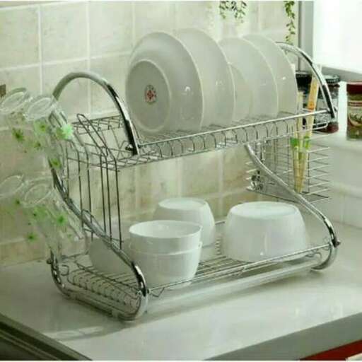 a metal dish rack with dishes in it.