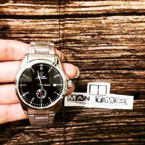 a man's hand with a watch on it.