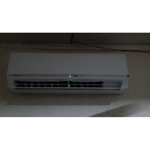 a white air conditioner in a room.