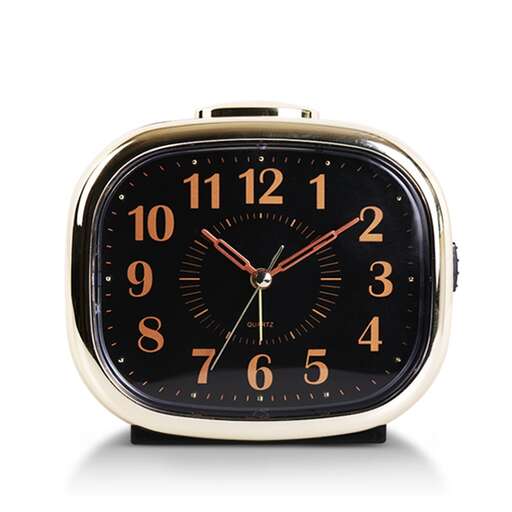 an alarm clock with a black face and gold trim.
