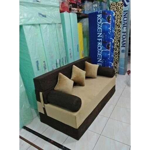 a couple of couches sitting on a tiled floor.