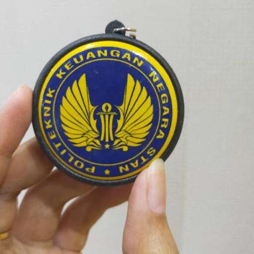 a hand holding a pocket watch with the logo on it.