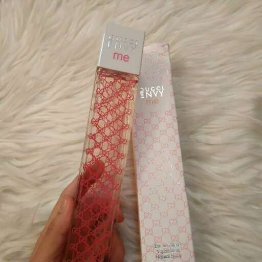 a hand holding a box of tissues and a box of tissues.