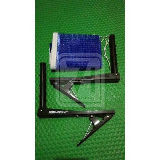 a pair of scissors and a comb on a green surface.