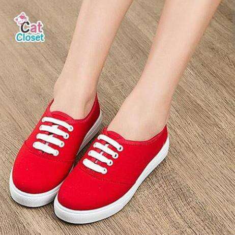 red shoes with white laces and a red sole