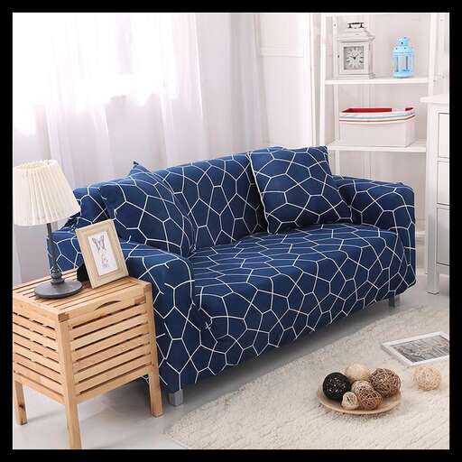 a blue couch sitting in a living room next to a table.