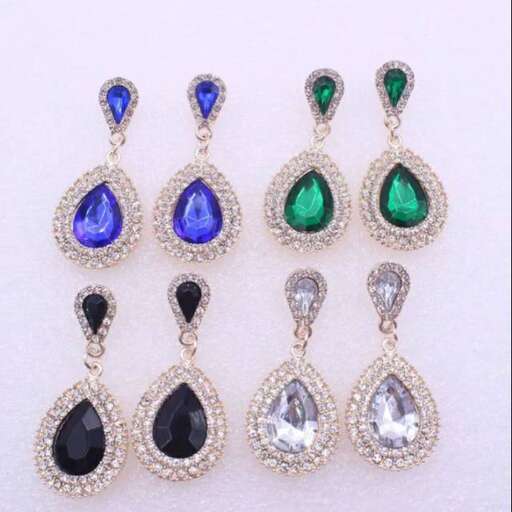 a set of earrings with emeralds and diamonds