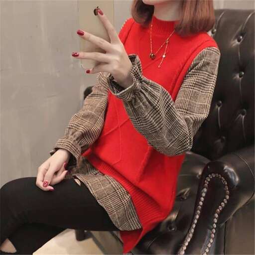 a red sweater with a black belt and black pants