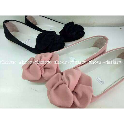 a pair of pink slippers with a bow.