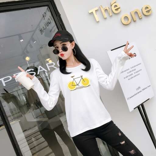 a girl poses in front of a storefront.