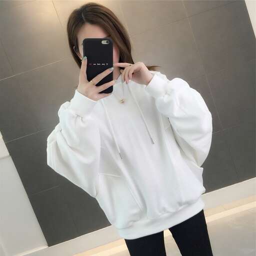 a woman taking a picture of herself with a cell phone.