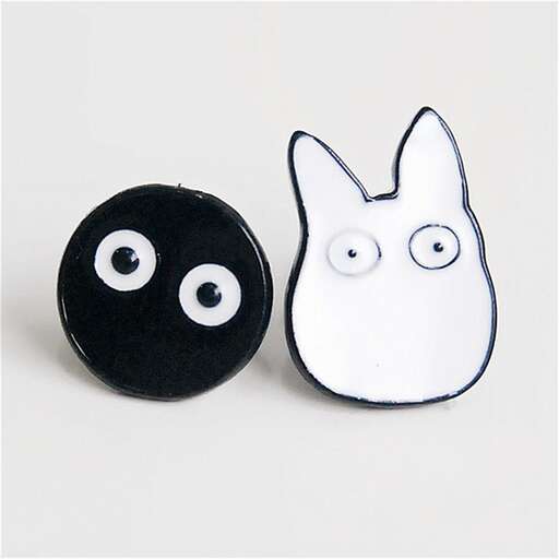 two cute little black and white buttons and a black and white cat.