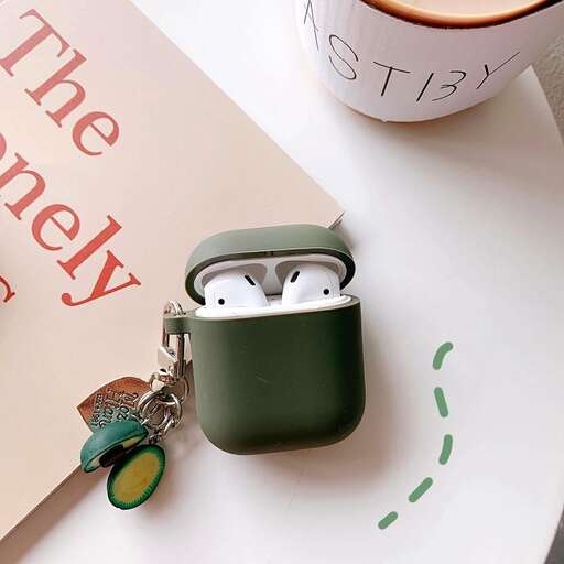 a green and white ipod holder with a card in the background.