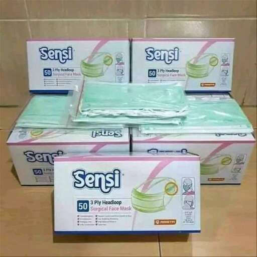 three boxes of bananas are stacked on a tile floor.