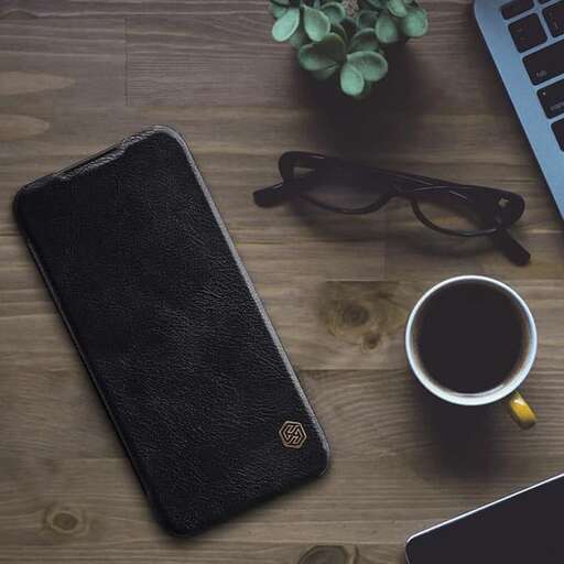 a black wallet and a laptop on a table.