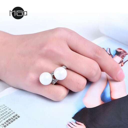 a woman's hand with a ring on it.