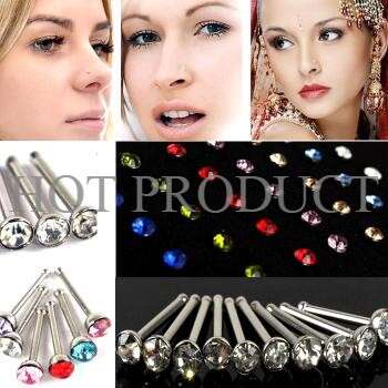 a set of earrings with a lady in the background.