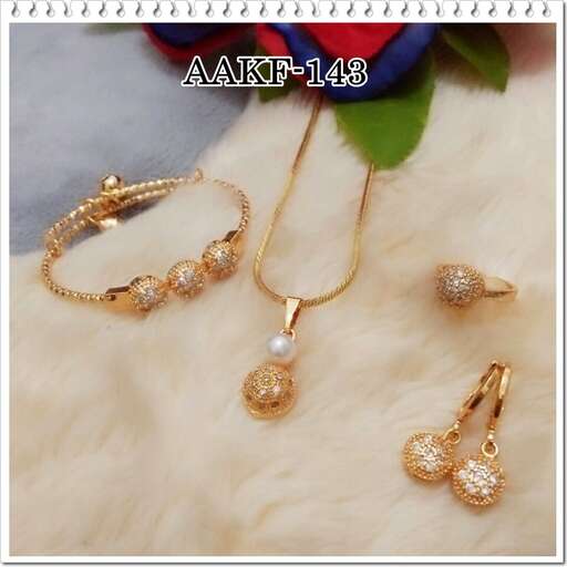 a set of 18k gold jewelry with diamonds and a pearl necklace.