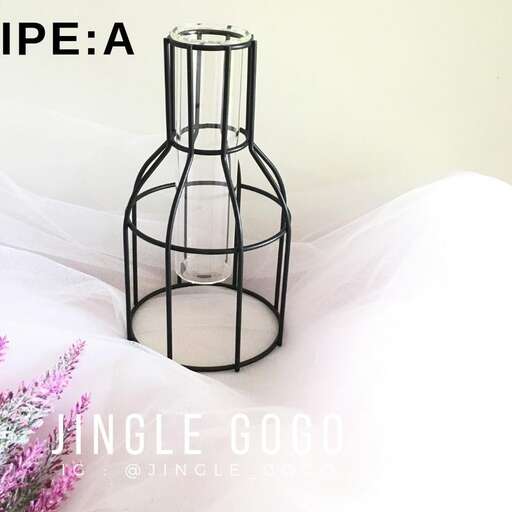 a small black lamp with a wire cage on top of it.