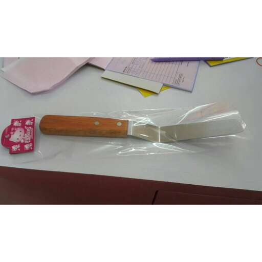 a wooden spoon sitting on top of a white table.