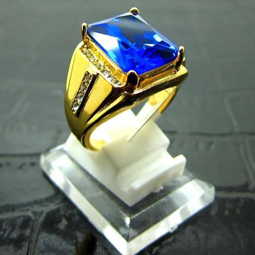 a ring with a blue sapphire and diamond.