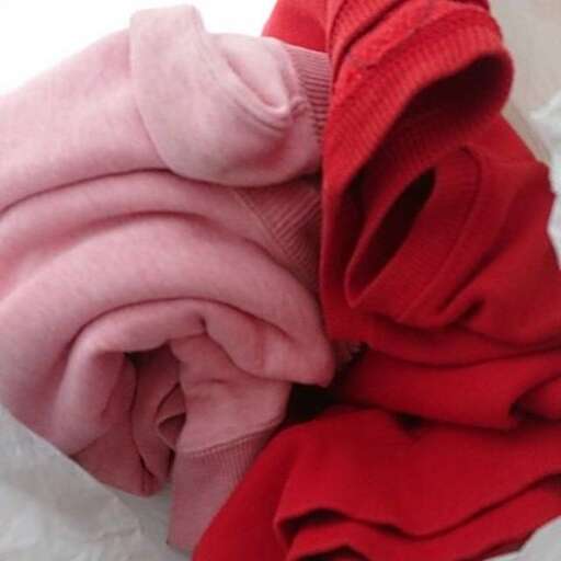 a pink blanket with a red shirt on it
