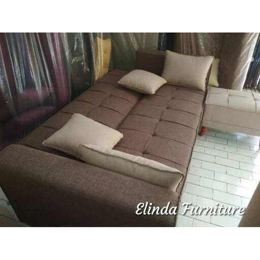 a bed with a white and brown bedding.