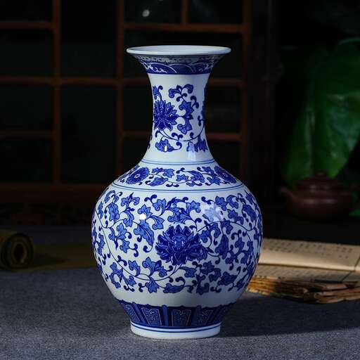 a blue and white vase sitting on a table.