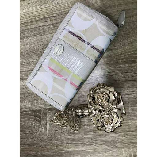 a bag of gold jewelry on a wooden table.