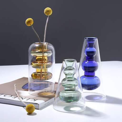 a table with a book and a couple of vases.