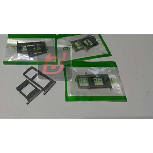 a set of green and black cell phones in plastic.