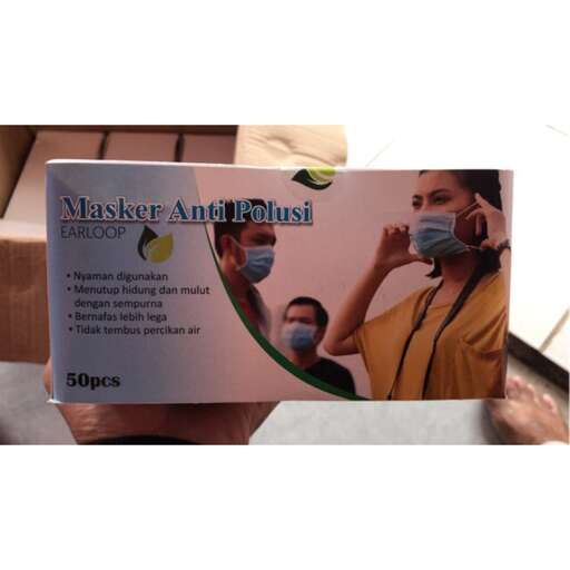 a person holding a sign with a picture of a person in a mask.