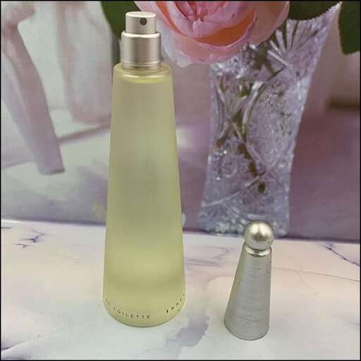 a bottle of perfume sitting on top of a table.