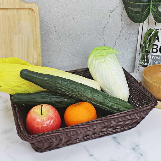 a basket of vegetables and fruits on a counter.