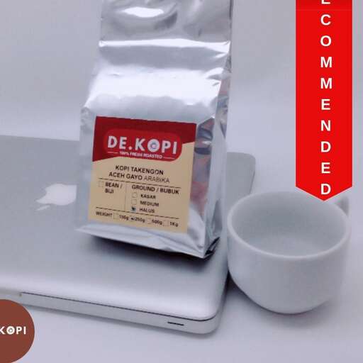 a cup of coffee on a laptop