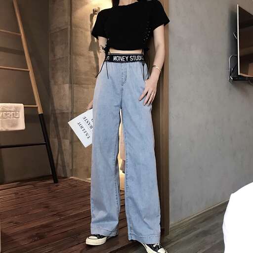 a model shows off her new collection of high - waisted jeans.