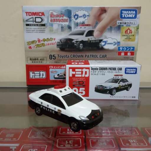 a toy car is on display with other items.