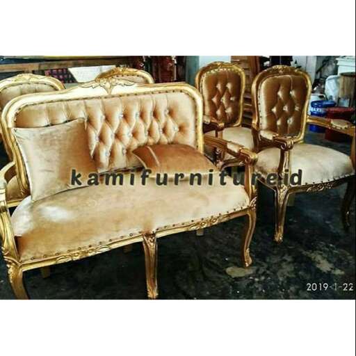 a pair of gold and white chairs