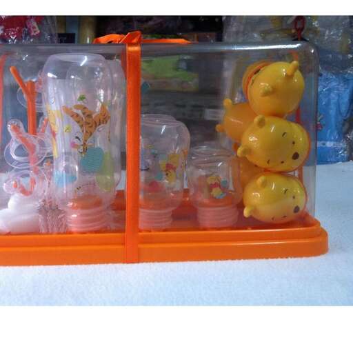 a display case with three glass containers and three orange ones.